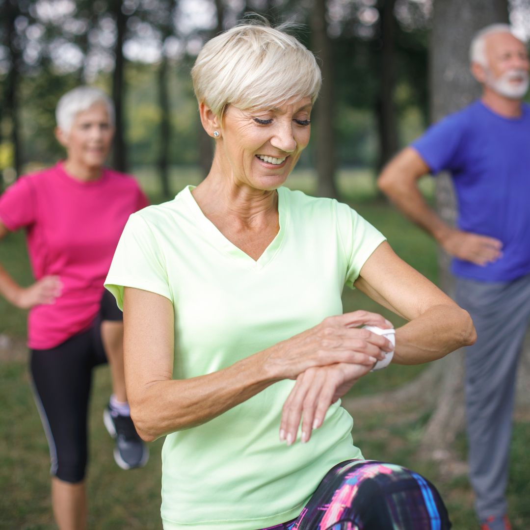 Image of a senior lady checking her vital signs during an aerobic/cardio workout session.