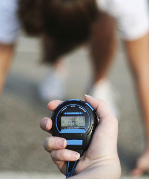 Image of a physical fitness tester starting her stopwatch.