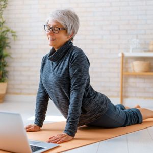 Image of senior lady using a pre-recorded/on-demand format to exercise.