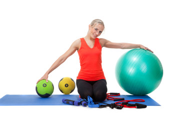 Image of Fitness Professional modeling with different types of fitness equipment, tools and resources.
