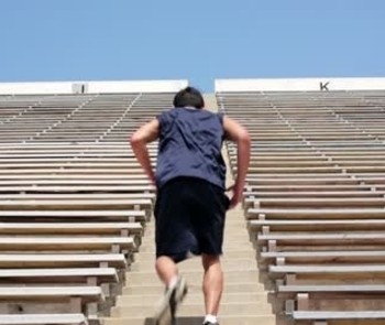 Image of a middle-aged man running up stairs.