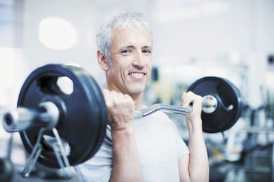 Image of an older adult male lifting weights.