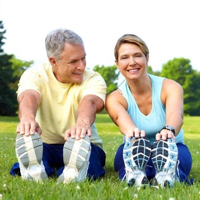 Image of a senior couple exercising outdoors.