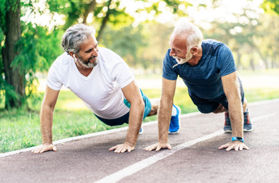 Image of two senior men exercising in the real world context.