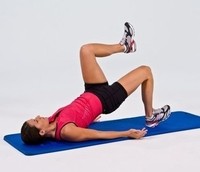 Picture of a lady performing a core exercise on the floor.