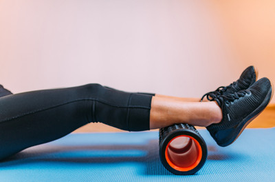 Image of a fitness client using a foam roller during a workout.