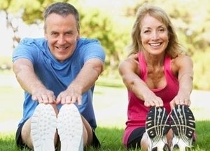 Image of a middle-aged couple exercising outdoors.
