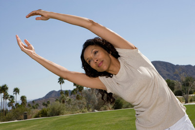 Image of a mid-life lady doing stretches.