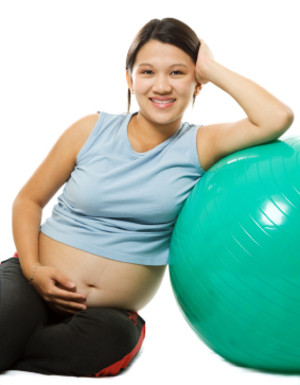 Image of a pre-post natal fitness client taking a break from training. 
