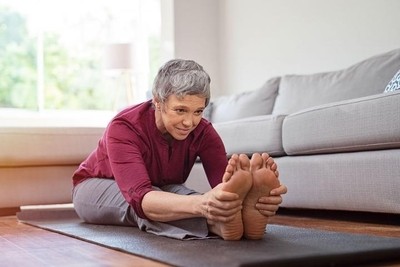 Image of a senior lady exercising at home.