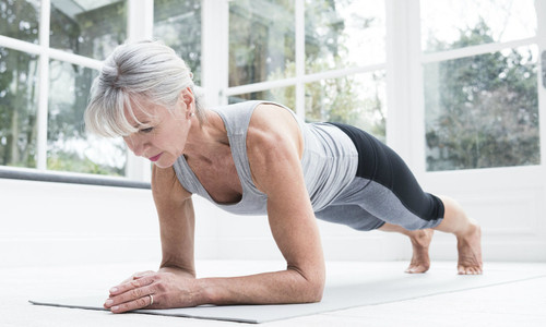 Image of a senior lady doing a plank.